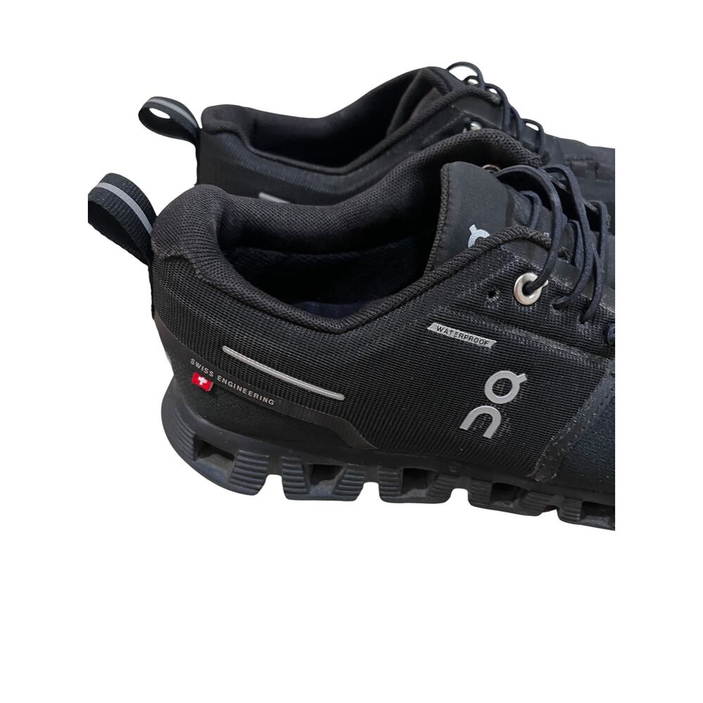 On Cloud waterproof running shoes for women in solid black. - Picture 5 of 9